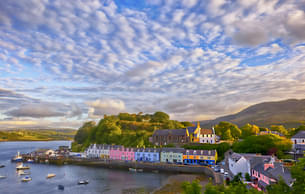 Immerse yourself in the charm of Portree, a harbor town framed by colorful houses and rugged cliffs