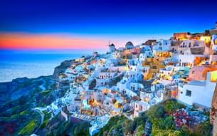 Watch a stunning sunset in Oia Town on this Italy, Greece and Turkey Tour