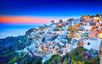 Watch a stunning sunset in Oia Town on this Italy, Greece and Turkey Tour