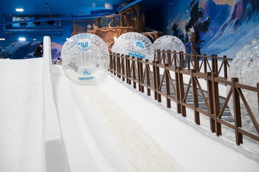 Get inside the inflatable ball & rolldown the snowy slide