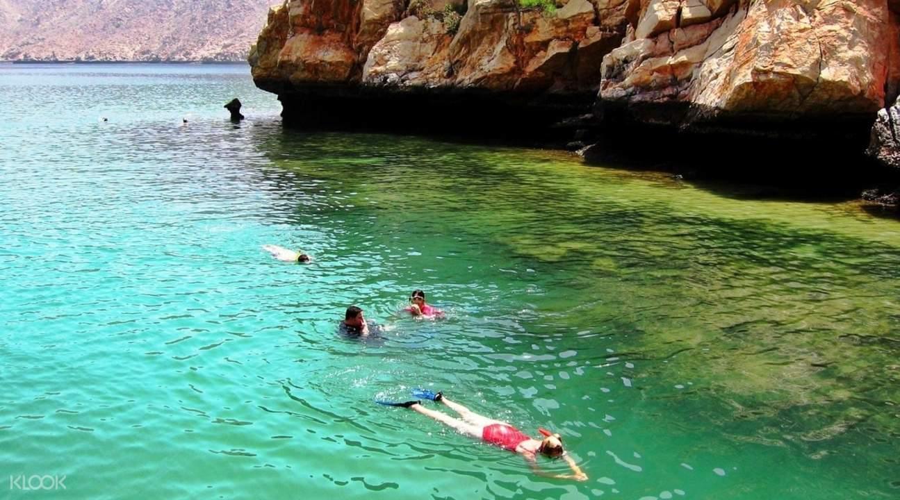 Snorkel in clear waters of Oman