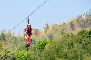 Glide through the skies with a thrilling cycling experience above the scenic Bir Valley