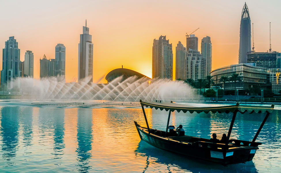 Witness the stunning fountain show against the backdrop of a sunset.