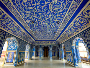 Walk the grand halls of City Palace adorned with intricate designs
