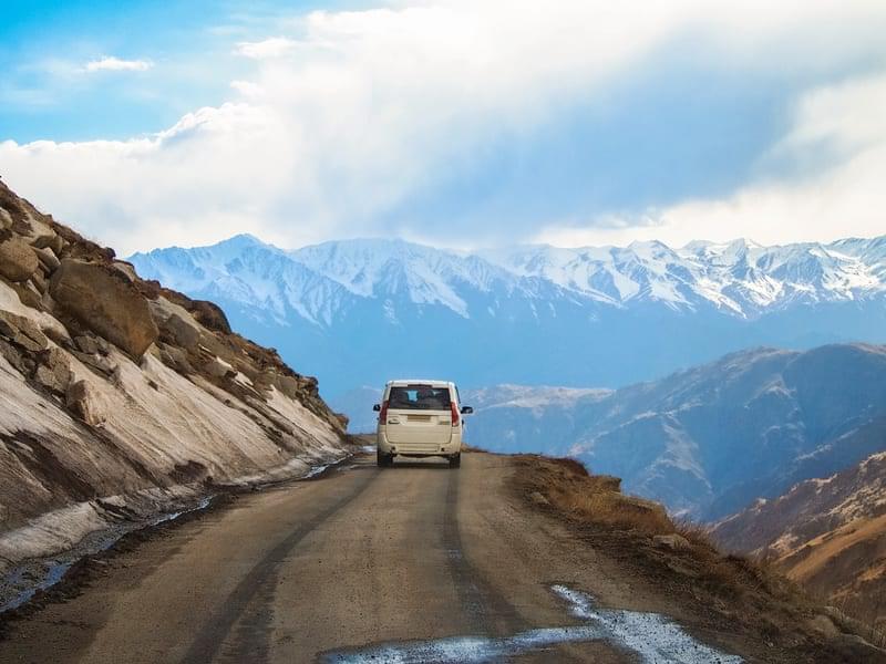 A drive through the snow capped valley of mountains!