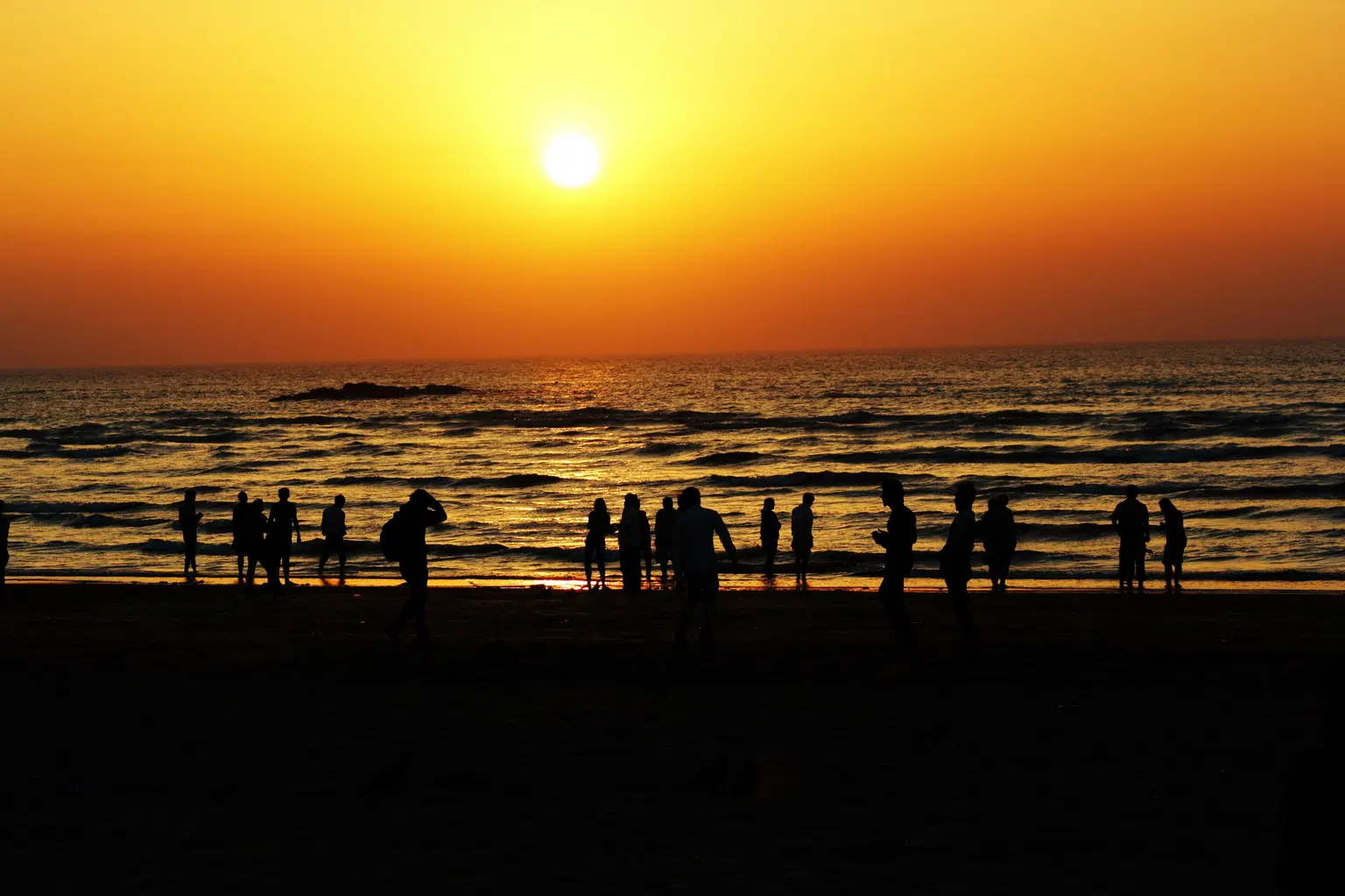 Watch a golden sunset over calm waters
